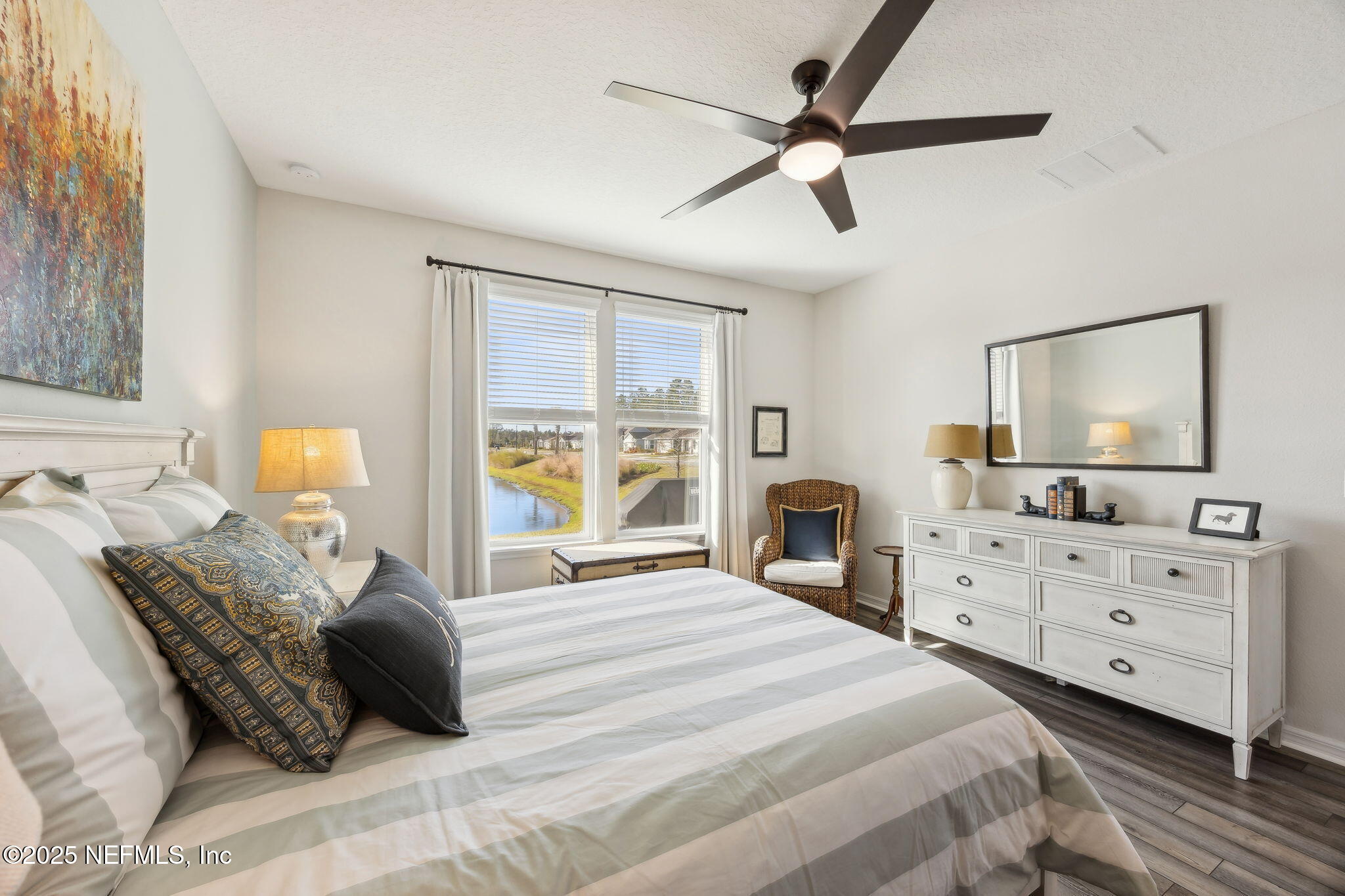 671 Jubilee Circle Yulee, FL 32097 - Photo 20 of 126 a bedroom with a bed window and a flat screen tv