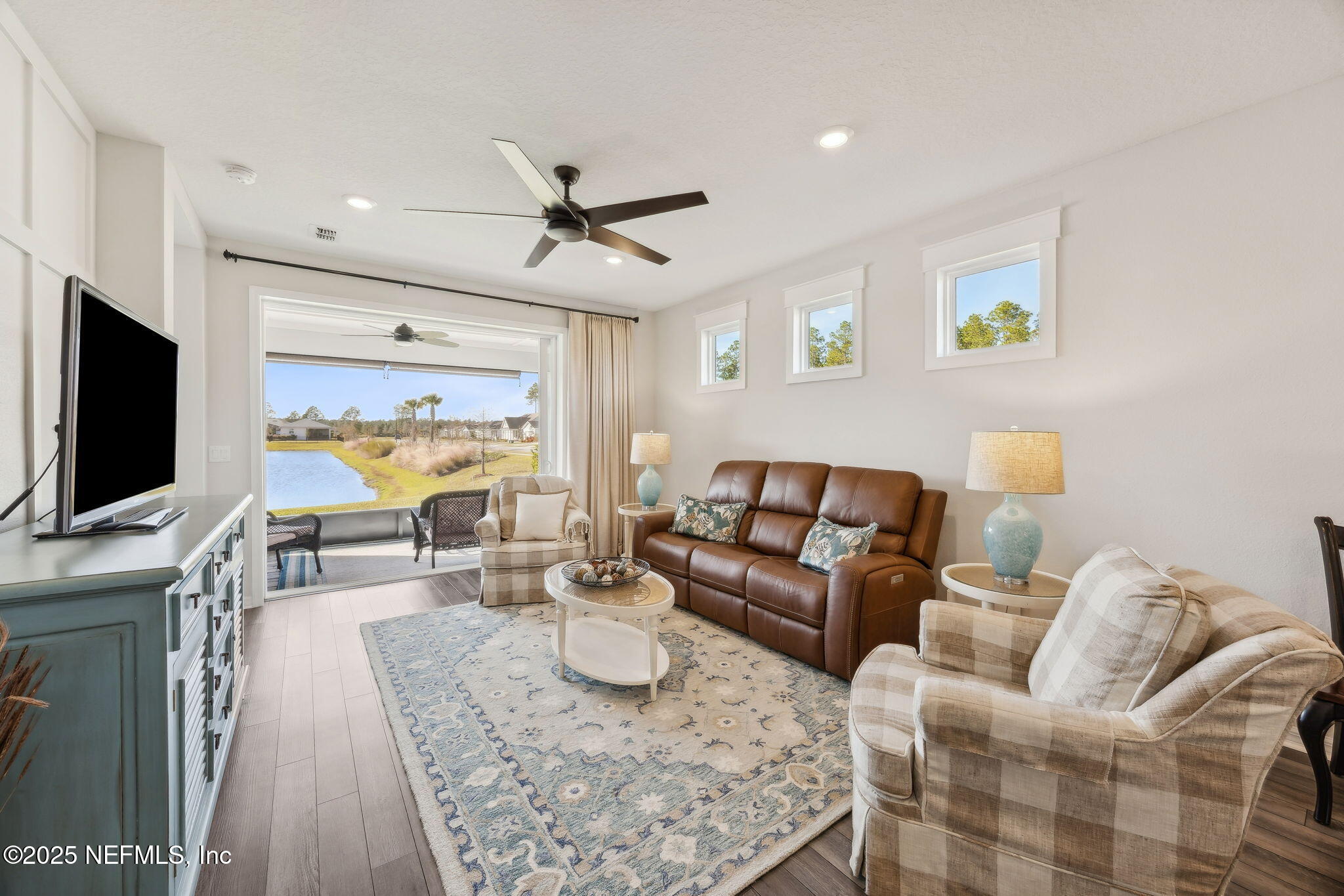 671 Jubilee Circle Yulee, FL 32097 - Photo 3 of 126 a living room with furniture and a flat screen tv