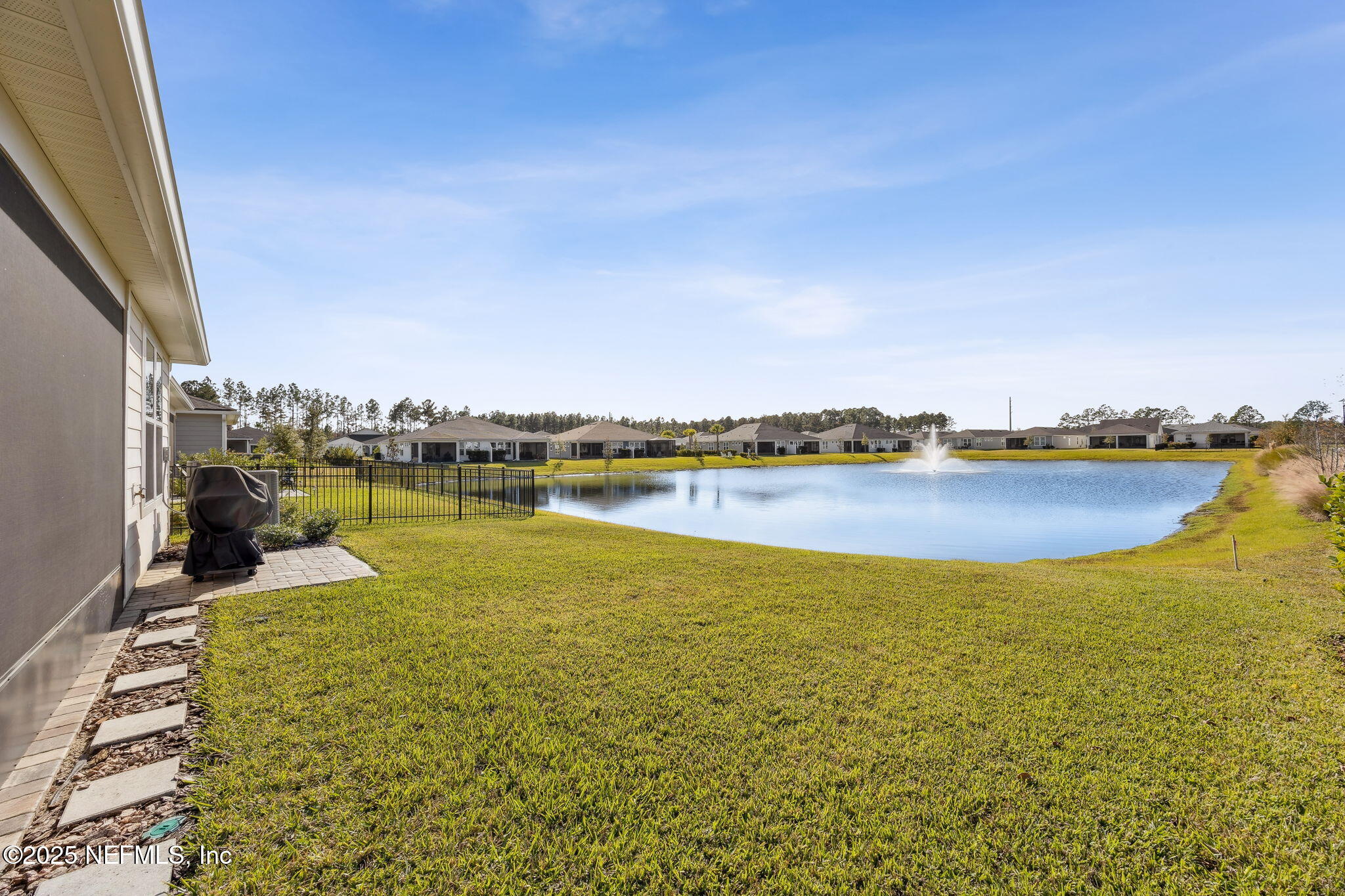 671 Jubilee Circle Yulee, FL 32097 - Photo 36 of 126 a view of a lake with houses in the back