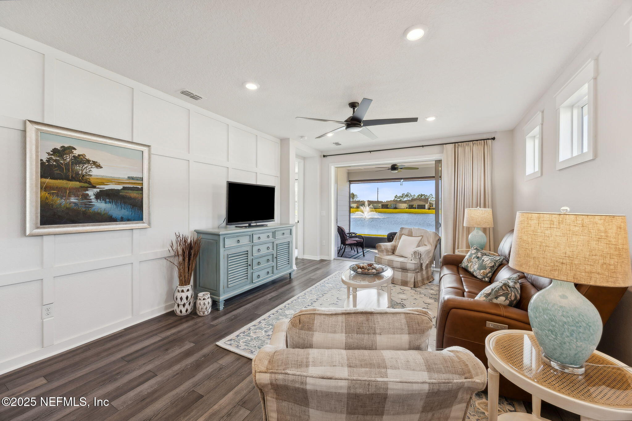 671 Jubilee Circle Yulee, FL 32097 - Photo 4 of 126 a living room with furniture and a flat screen tv