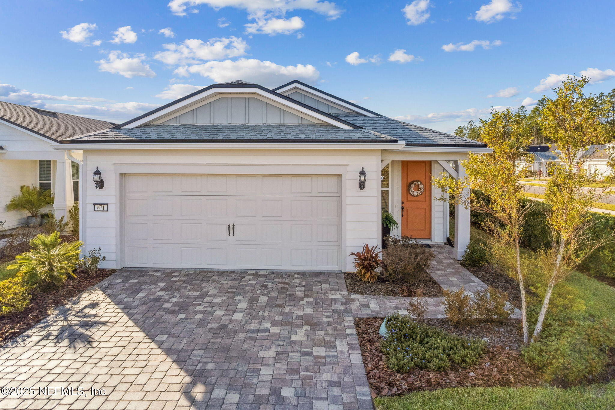 671 Jubilee Circle Yulee, FL 32097 - Photo 42 of 126 a front view of a house with garden
