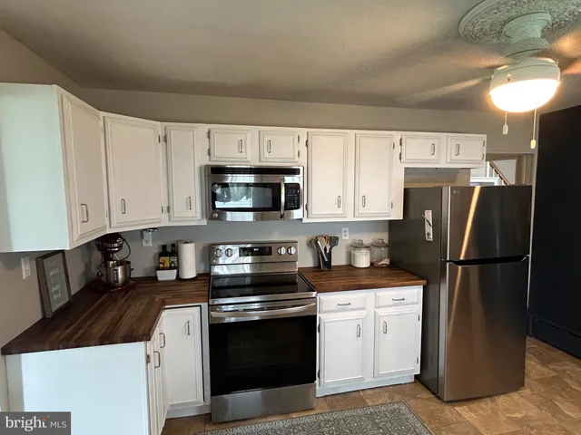 a kitchen with stainless steel appliances granite countertop a stove and a refrigerator