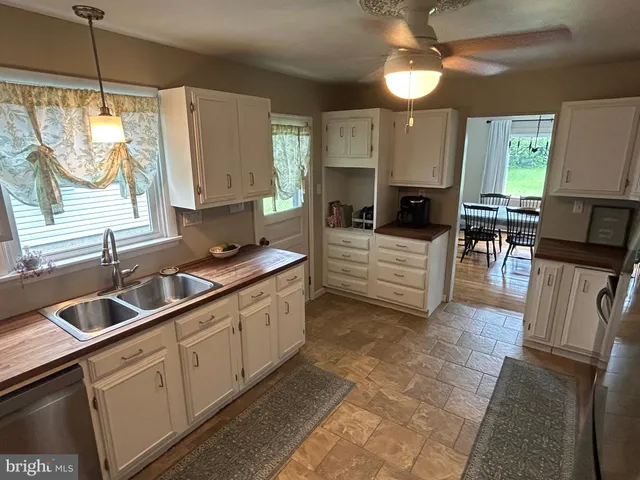 a kitchen with cabinets appliances and a counter space