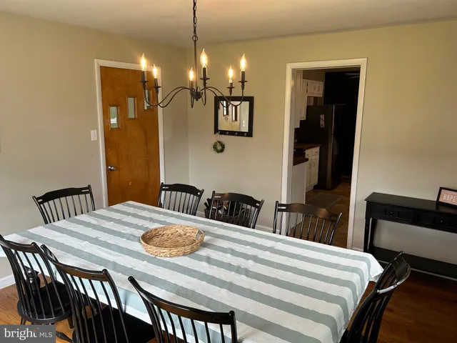 a living room with furniture a chandelier and a window