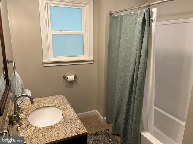 a bedroom with bed and a window