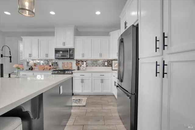 a kitchen with a refrigerator a sink and cabinets