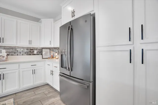 a kitchen with stainless steel appliances a refrigerator and cabinets