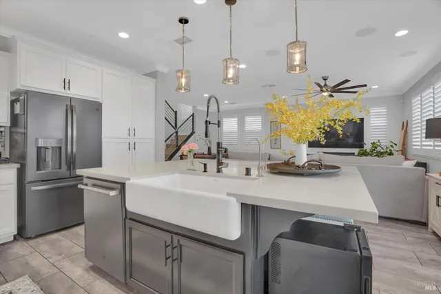 a kitchen with kitchen island a sink appliances and a counter top space