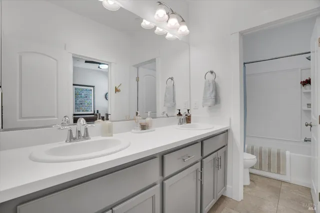 a bathroom with a sink double vanity and a mirror