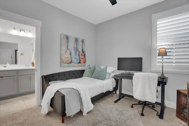 a bedroom with a bed and a desk