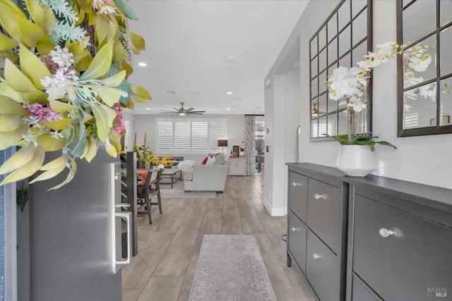 a living room with furniture a chandelier and a potted plant