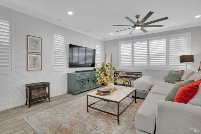 a living room with furniture a window and a flat screen tv