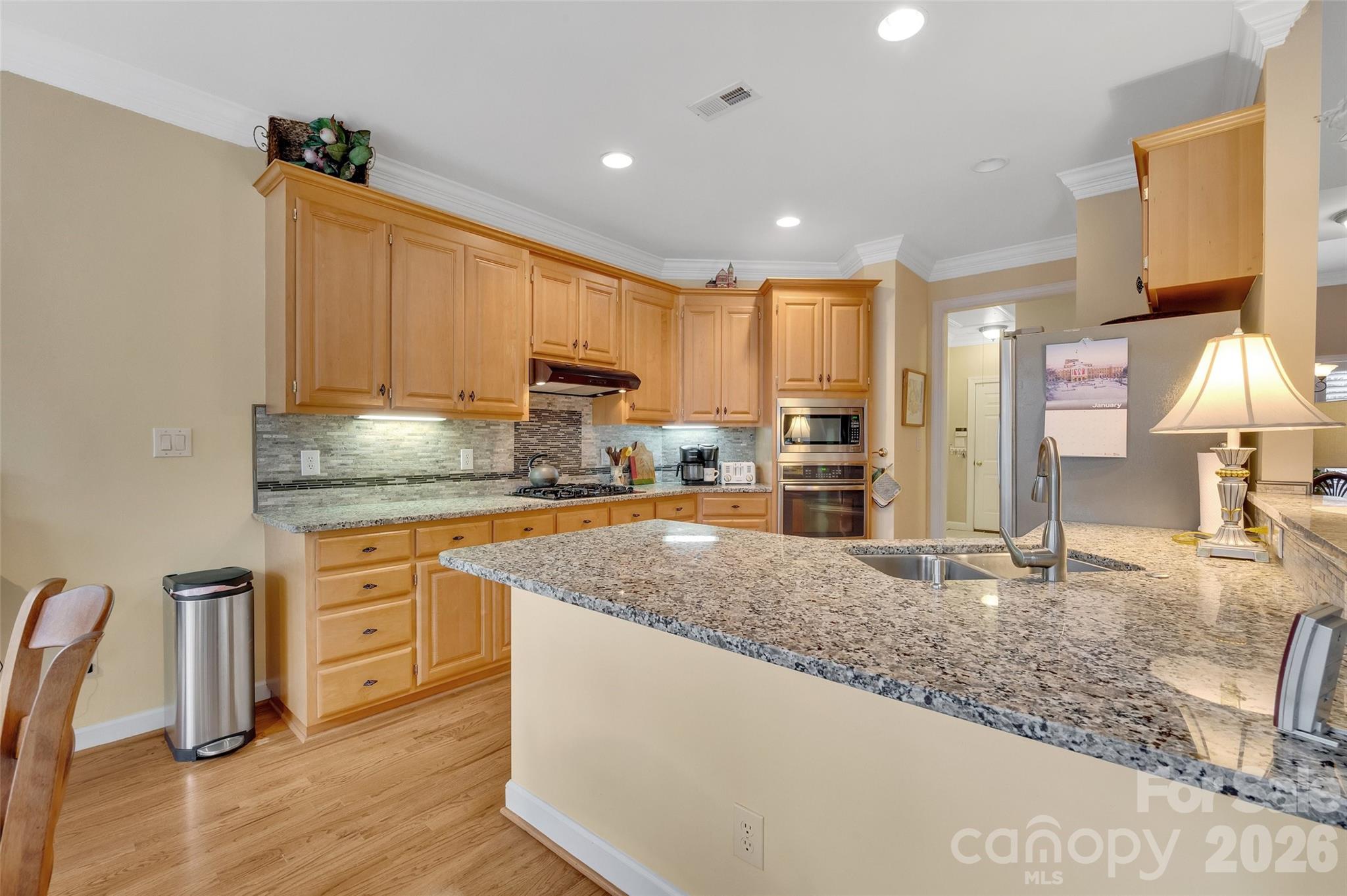 3001 River Bend Drive Tega Cay, SC 29708 - Photo 12 of 36 a kitchen with stainless steel appliances granite countertop a sink refrigerator and cabinets