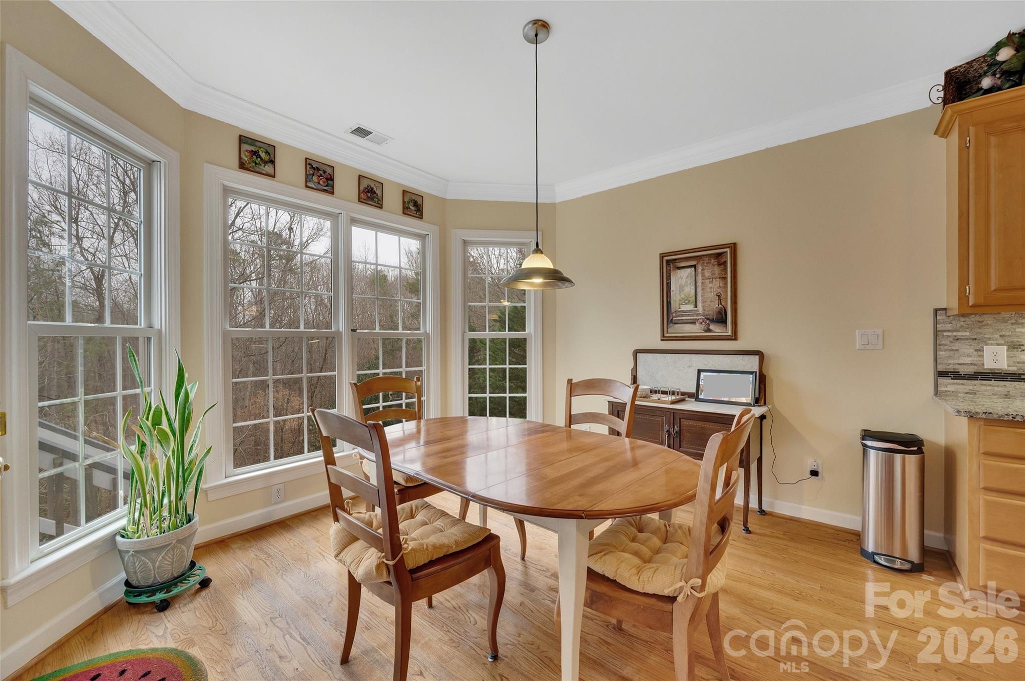 3001 River Bend Drive Tega Cay, SC 29708 - Photo 13 of 36 a view of a dining room with furniture window and wooden floor