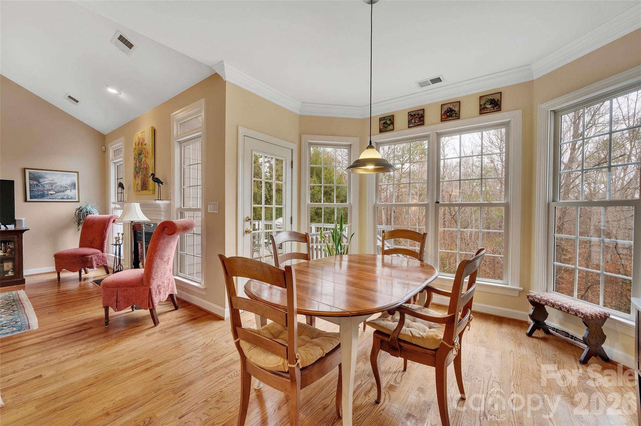 3001 River Bend Drive Tega Cay, SC 29708 - Photo 14 of 36 a dining room with furniture a chandelier and wooden floor