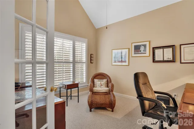 a view of a workspace with furniture and a window