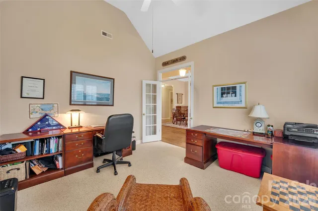 a view of a workspace with furniture and a workspace