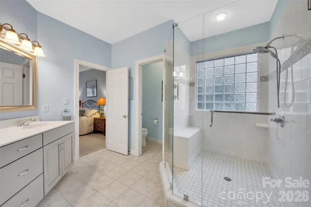 a bathroom with a double vanity sink toilet and shower