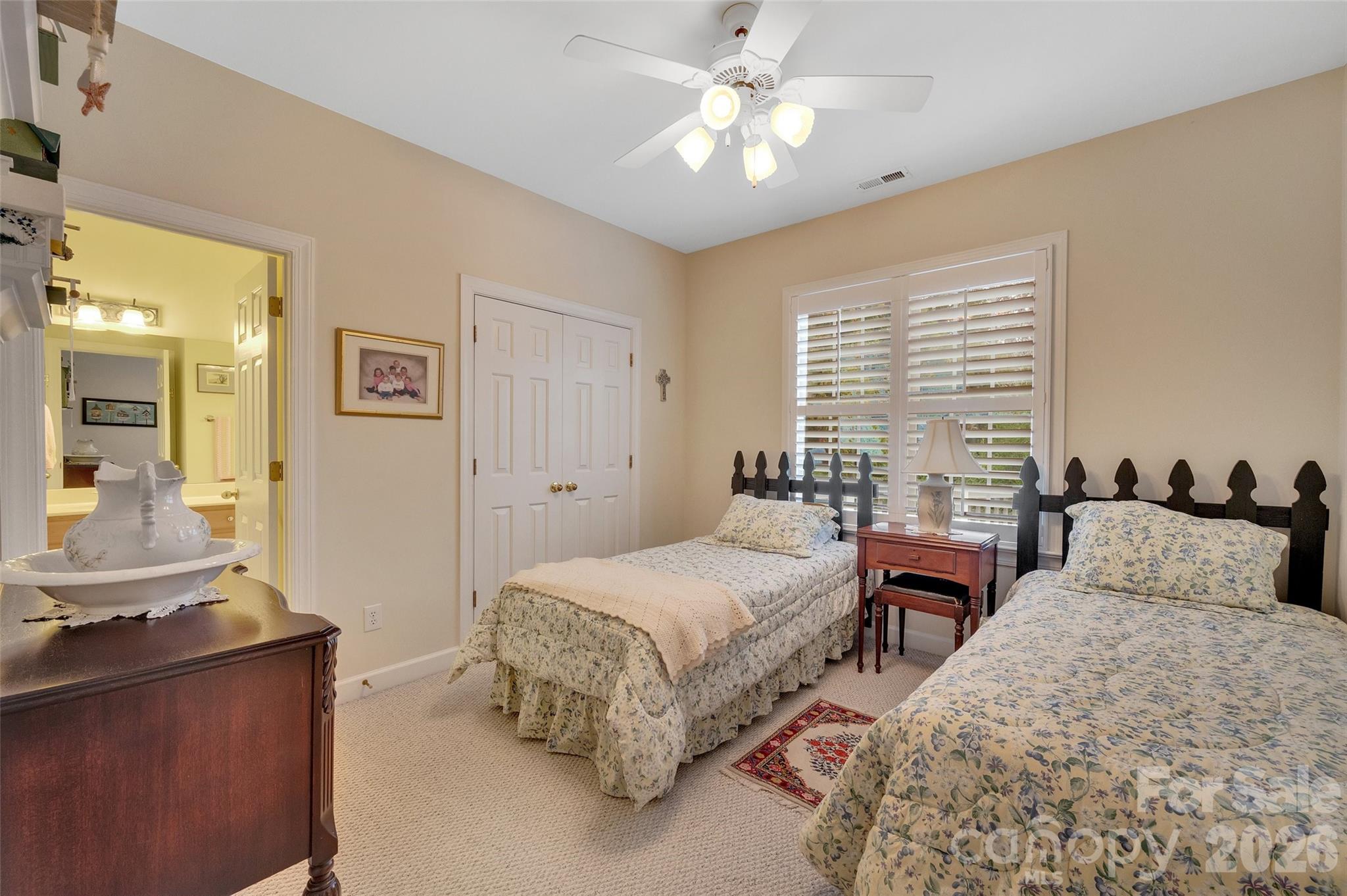 3001 River Bend Drive Tega Cay, SC 29708 - Photo 21 of 36 a bedroom with two beds and a chandelier