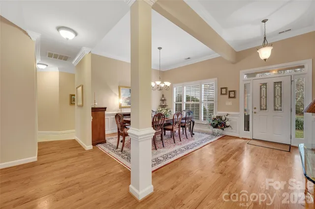 a view of a a dining room with furniture window and wooden floor