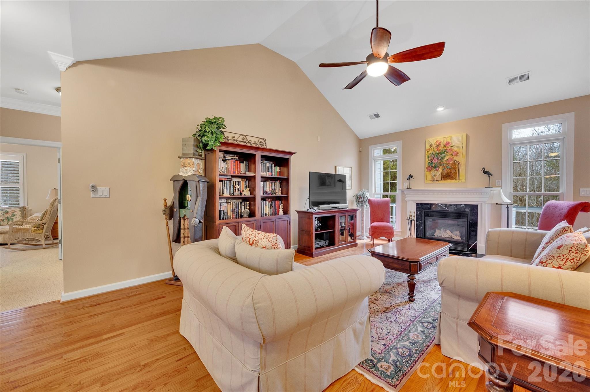 3001 River Bend Drive Tega Cay, SC 29708 - Photo 8 of 36 a living room with furniture a fireplace and a flat screen tv