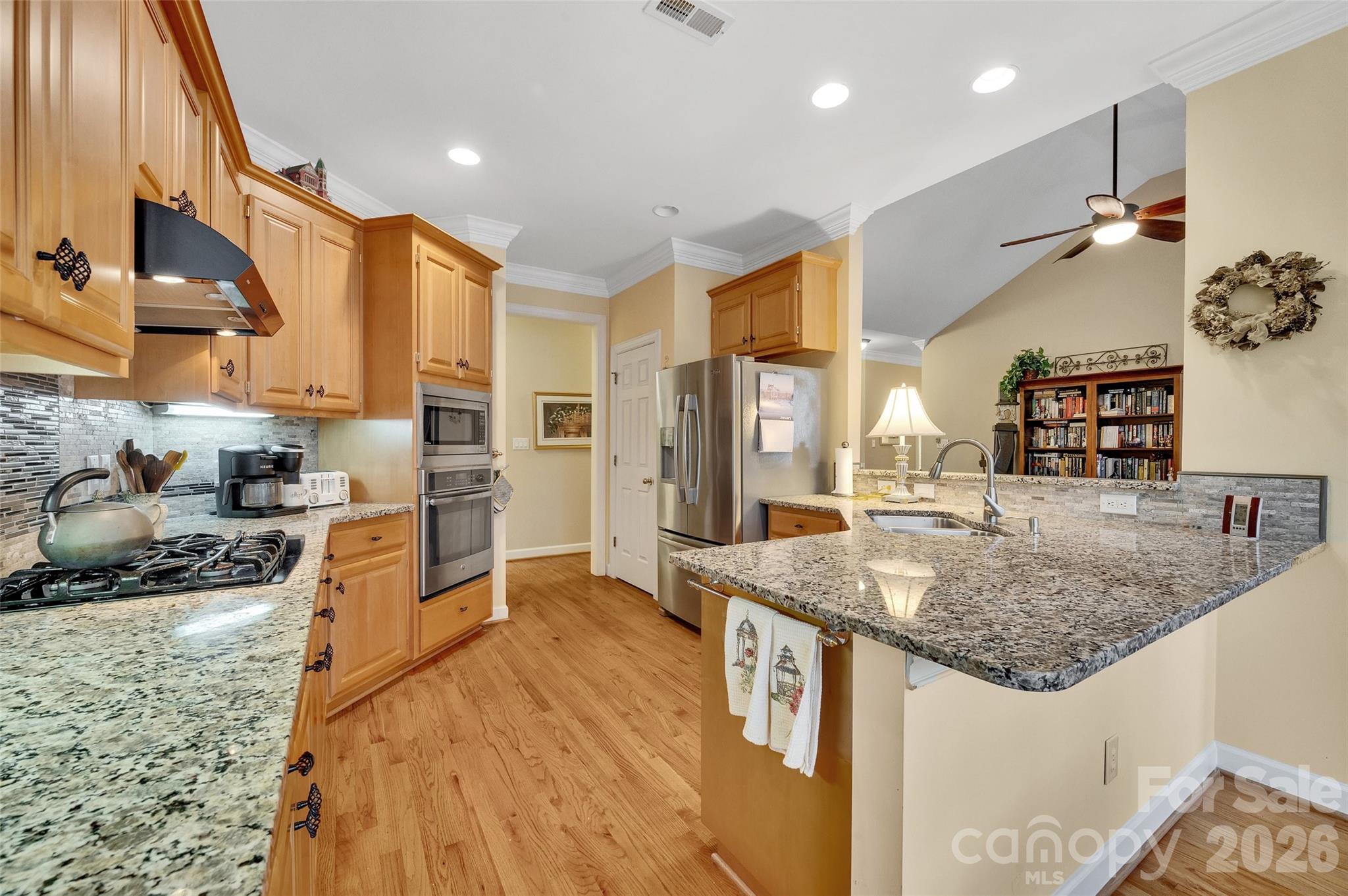 3001 River Bend Drive Tega Cay, SC 29708 - Photo 10 of 36 a kitchen with stainless steel appliances granite countertop a sink stove and refrigerator