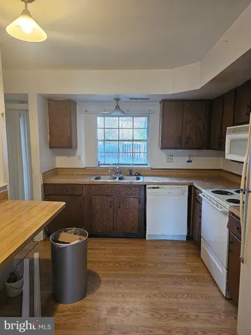 a kitchen with a stove a sink and a refrigerator