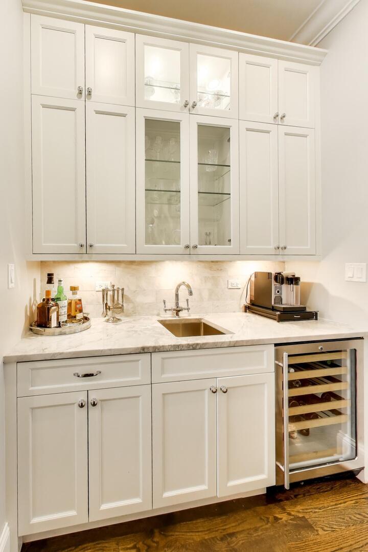1428 West George Street Chicago, IL 60657 - Photo 12 of 66 a kitchen with granite countertop white cabinets and sink