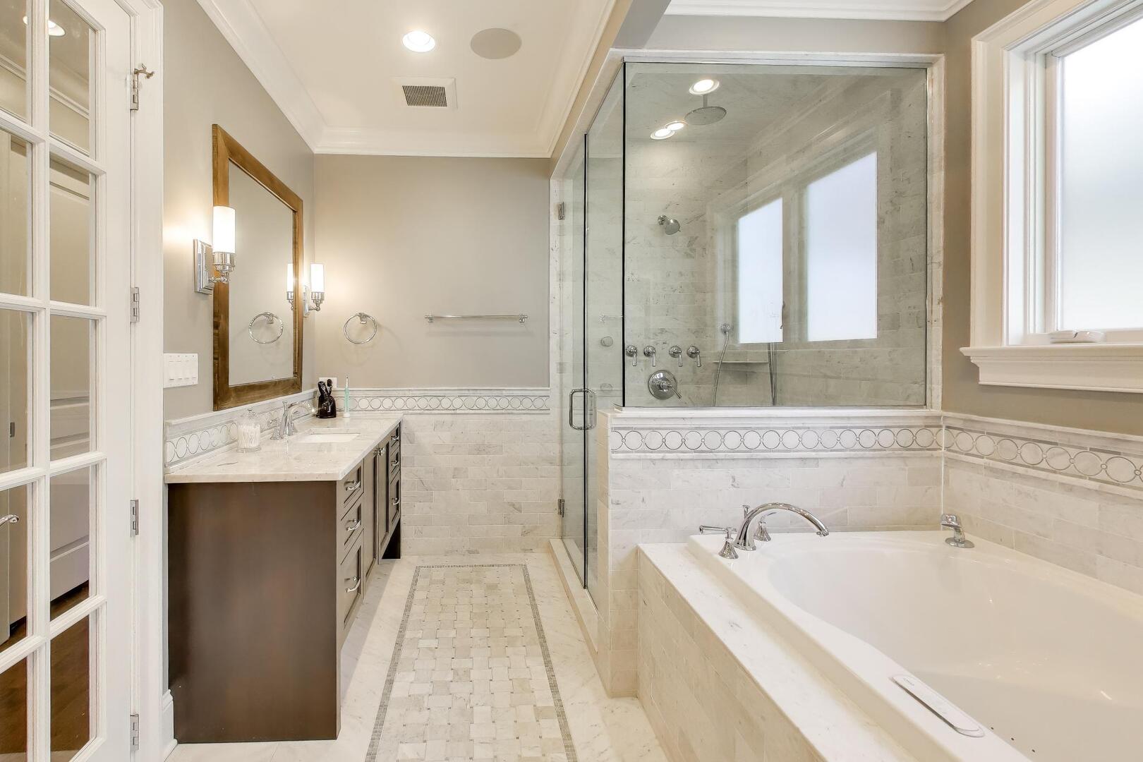 1428 West George Street Chicago, IL 60657 - Photo 21 of 66 a bathroom with a bathtub a sink and a large mirror