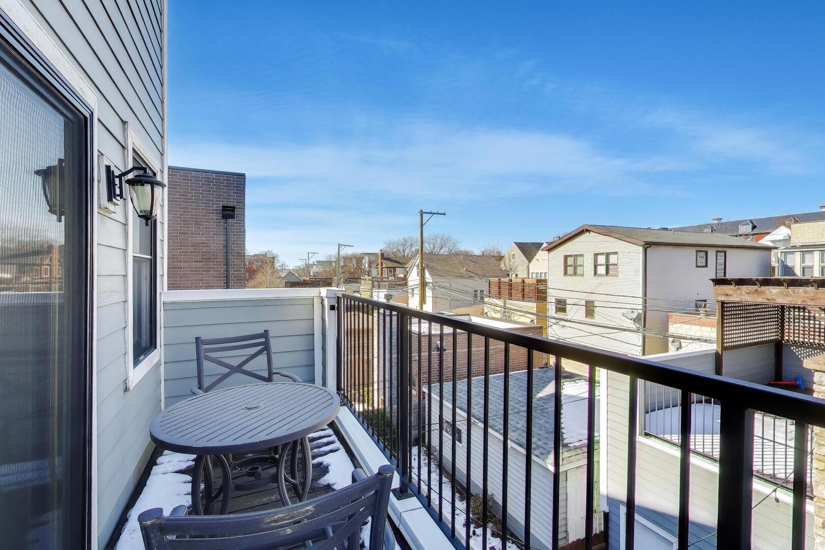 1428 West George Street Chicago, IL 60657 - Photo 24 of 66 a view of a balcony with furniture and a floor to ceiling window