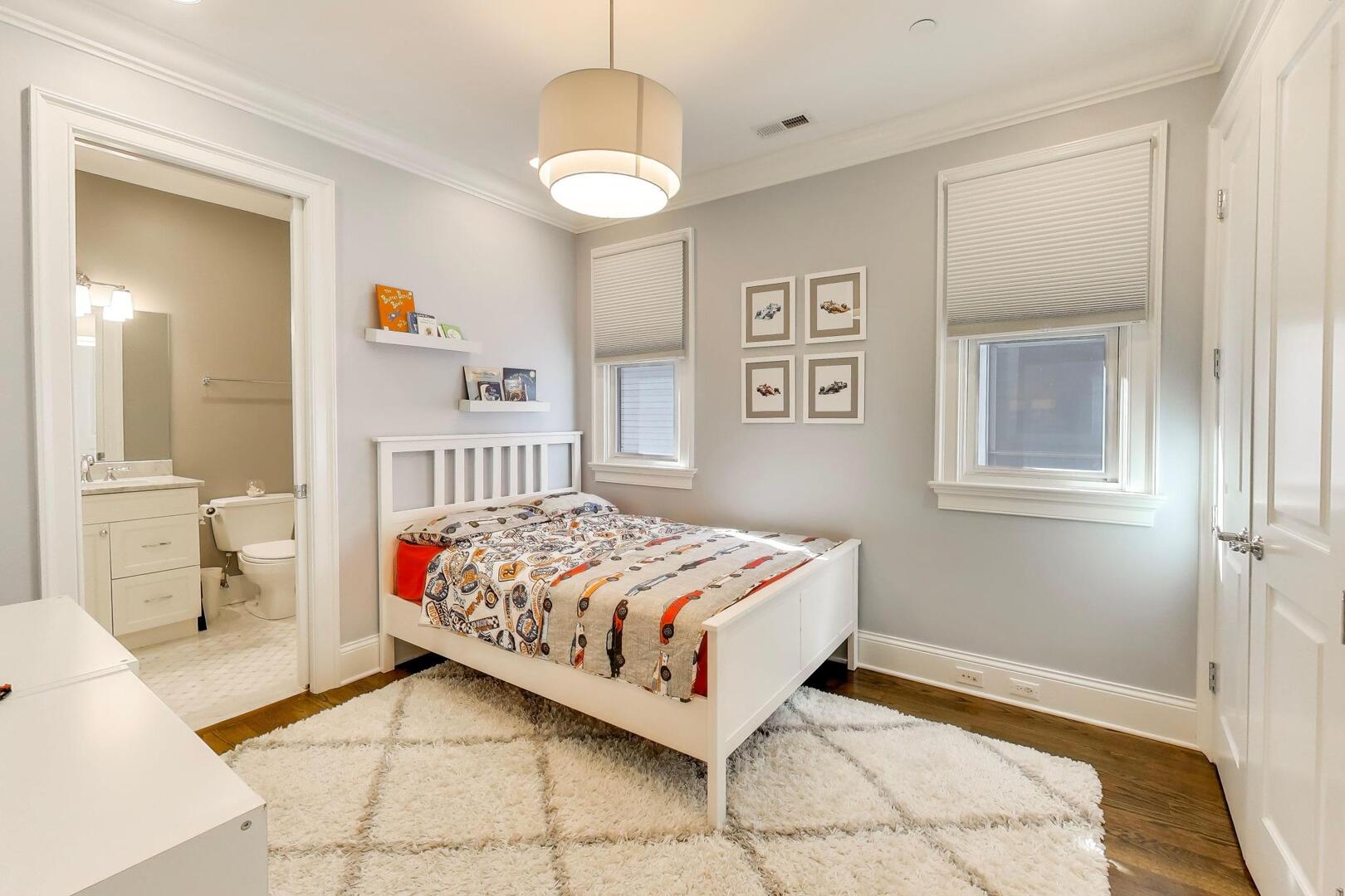 1428 West George Street Chicago, IL 60657 - Photo 25 of 66 a bedroom with a bed and a chandelier