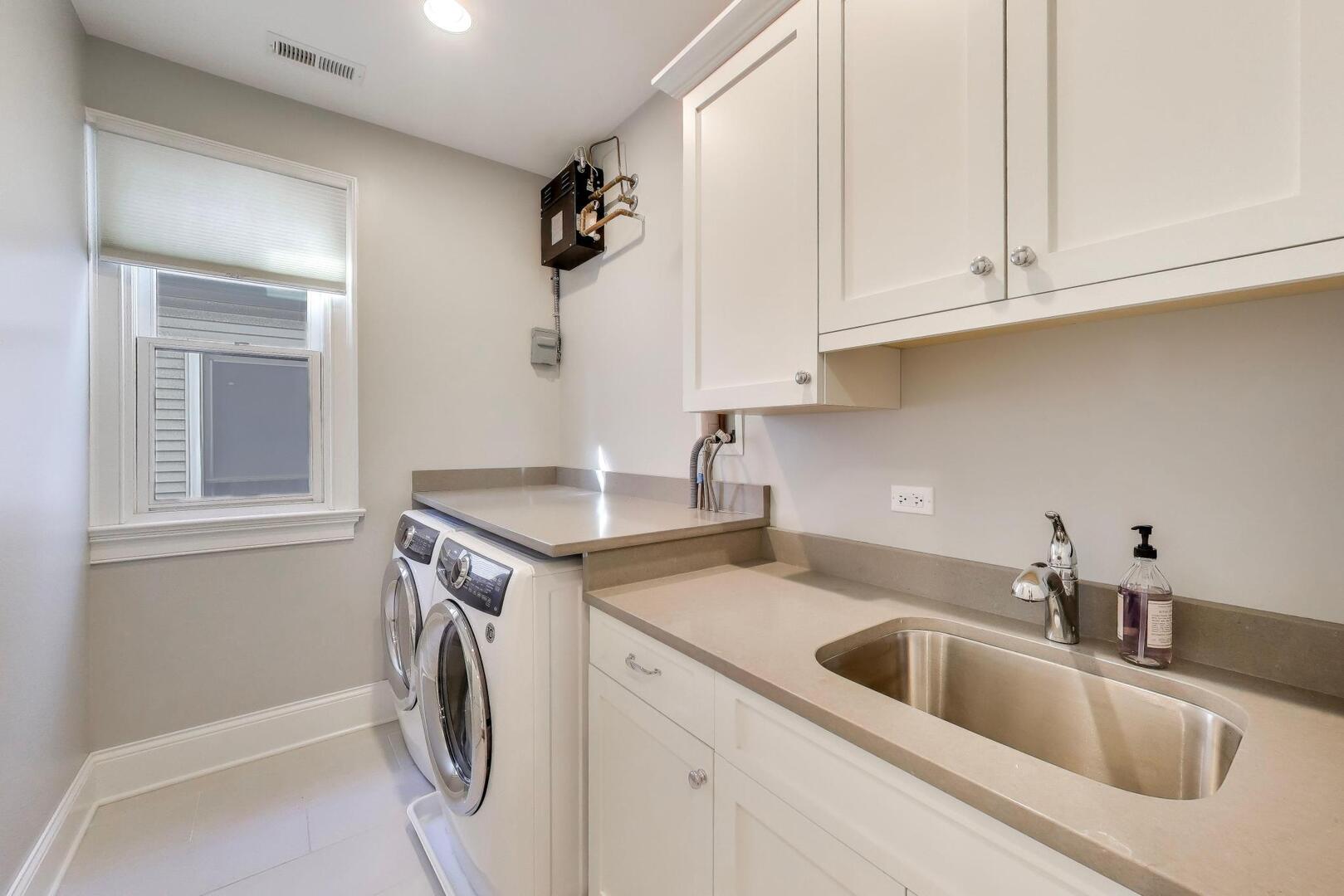 1428 West George Street Chicago, IL 60657 - Photo 32 of 66 a kitchen with a sink and cabinets