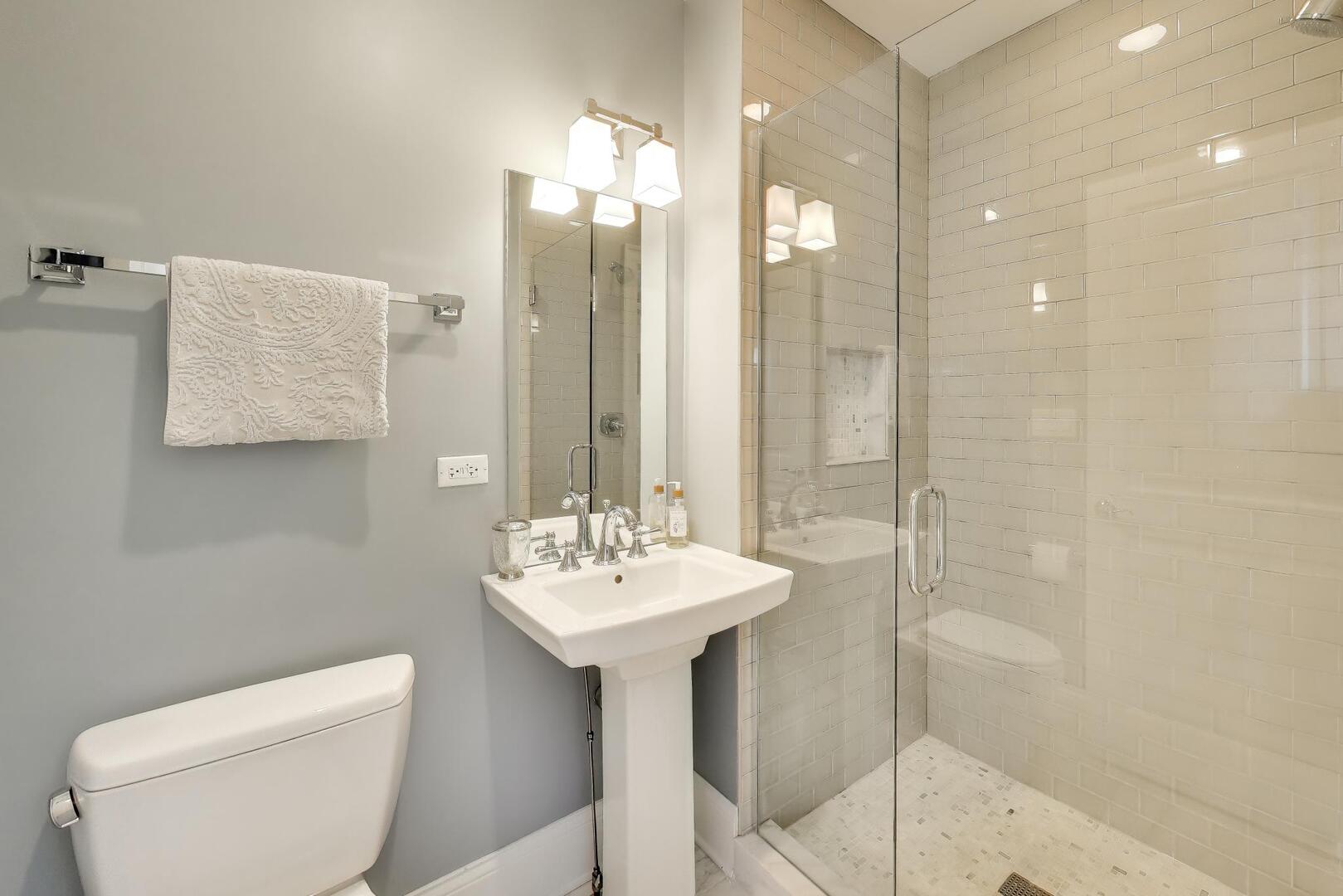 1428 West George Street Chicago, IL 60657 - Photo 38 of 66 a bathroom with a sink toilet and shower