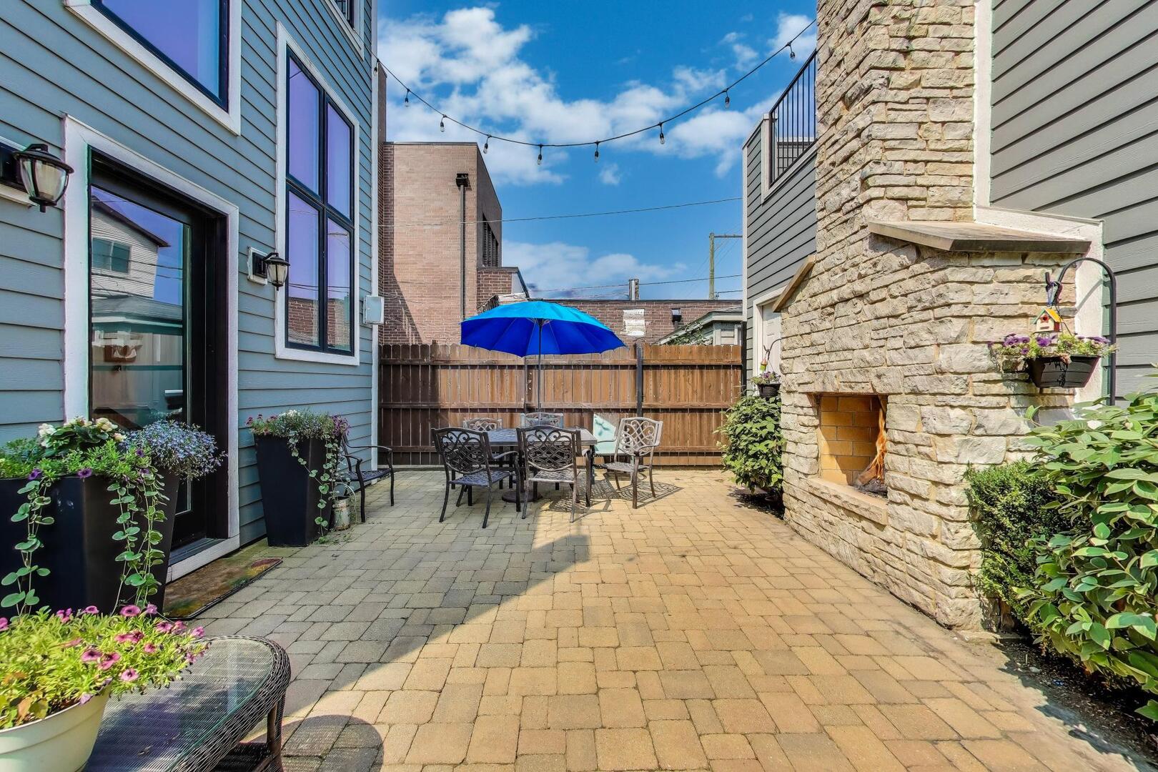 1428 West George Street Chicago, IL 60657 - Photo 56 of 66 a view of a patio with a table and chairs and potted plants