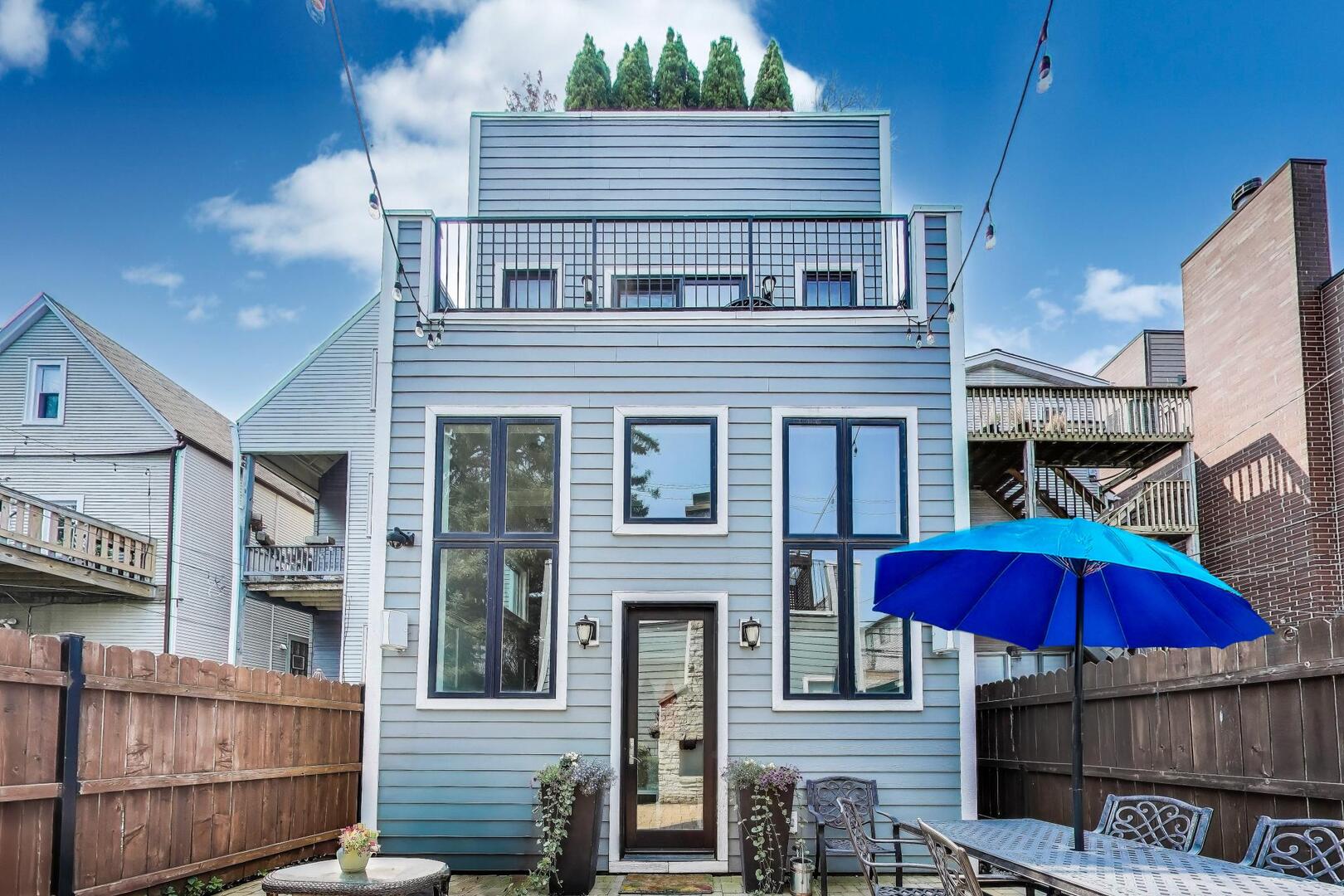 1428 West George Street Chicago, IL 60657 - Photo 59 of 66 a red brick house with red door and a car parked