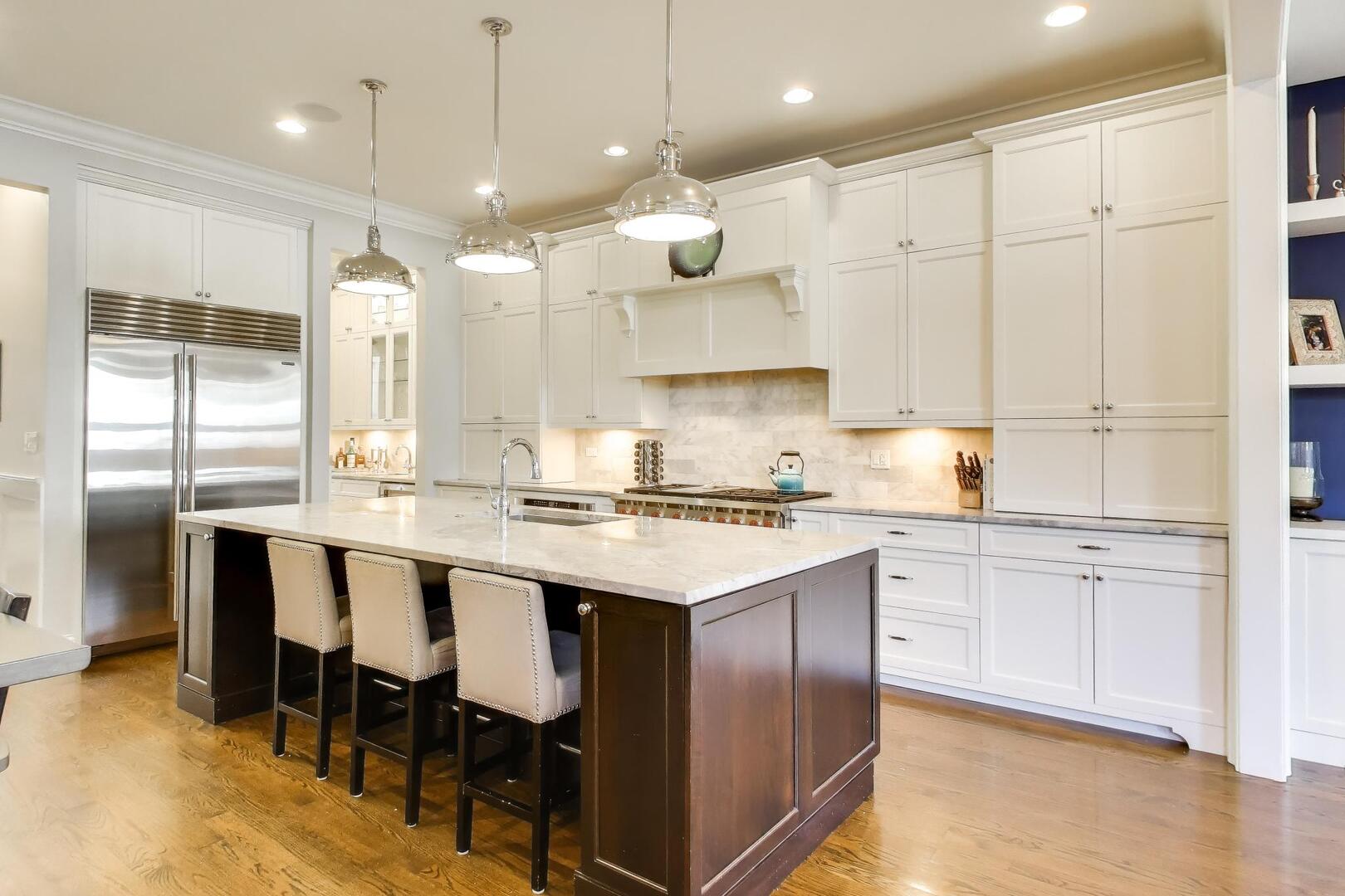 1428 West George Street Chicago, IL 60657 - Photo 6 of 66 a kitchen with stainless steel appliances granite countertop a sink a stove a refrigerator and island with wooden floor
