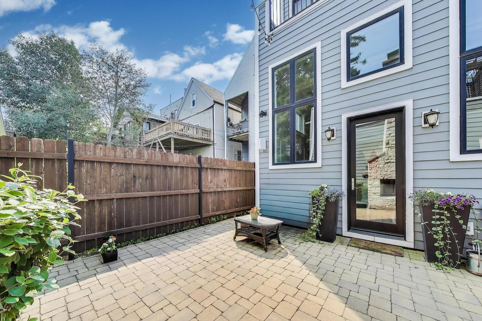 1428 West George Street Chicago, IL 60657 - Photo 63 of 75 a view of a chair and table in the backyard
