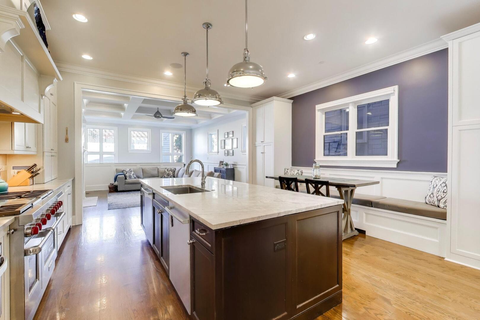 1428 West George Street Chicago, IL 60657 - Photo 9 of 66 a large kitchen with lots of counter space a sink appliances and a center island