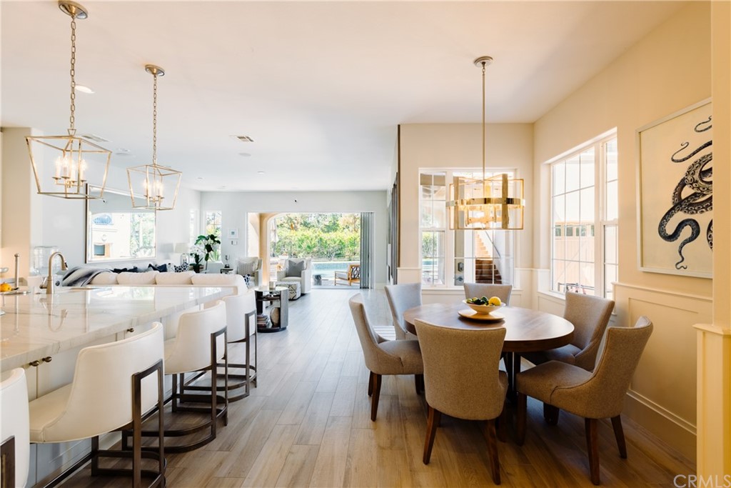 26 Seabluff Newport Beach, CA 92660 - Photo 14 of 59 a view of a dining room and livingroom with lots of furniture wooden floor a chandelier