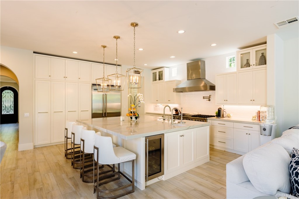 26 Seabluff Newport Beach, CA 92660 - Photo 16 of 59 a large kitchen with a table chairs refrigerator and cabinets