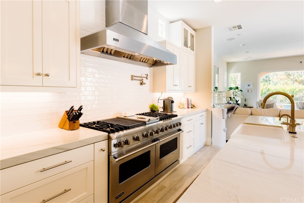 26 Seabluff Newport Beach, CA 92660 - Photo 17 of 59 a kitchen with stainless steel appliances a stove and white cabinets