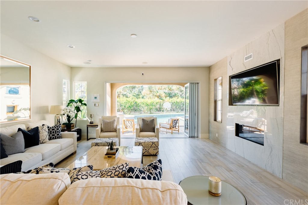 26 Seabluff Newport Beach, CA 92660 - Photo 19 of 59 a living room with furniture large window and a flat screen tv