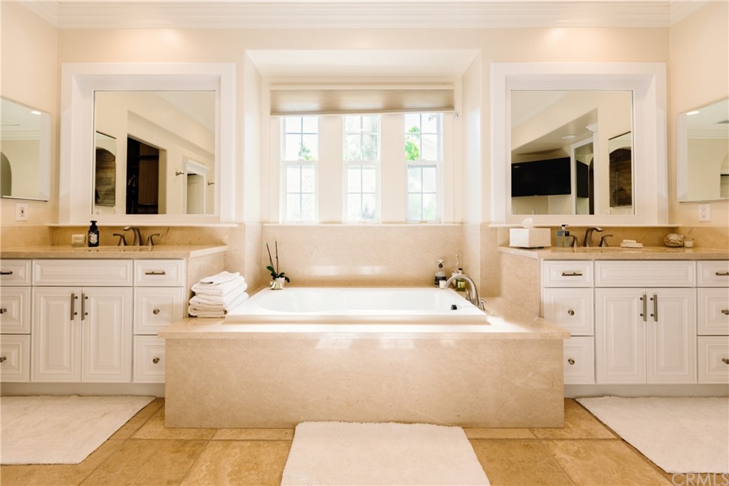 26 Seabluff Newport Beach, CA 92660 - Photo 28 of 59 a bathroom with a sink a large mirror and a bathtub