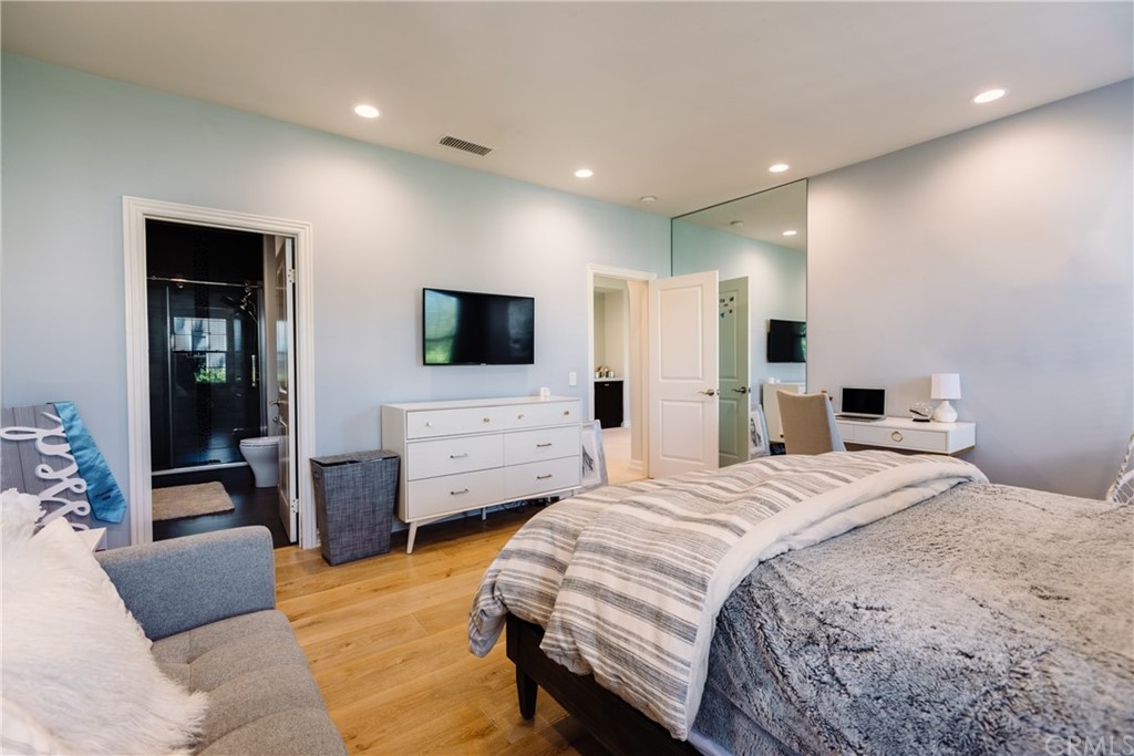 26 Seabluff Newport Beach, CA 92660 - Photo 33 of 59 a spacious bedroom with a bed and a flat screen television