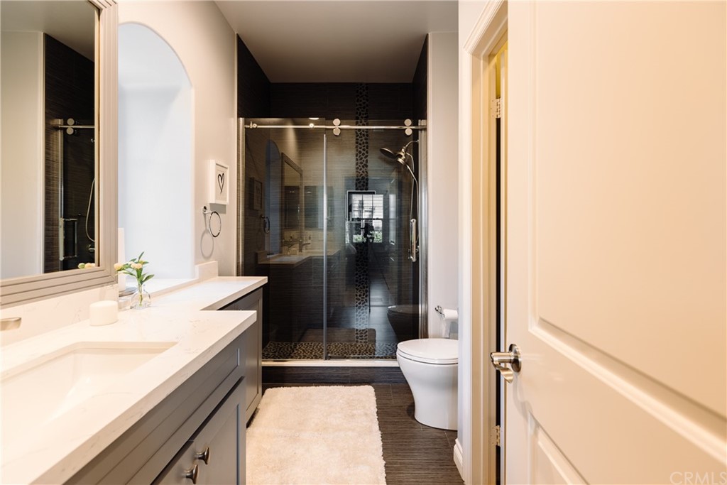 26 Seabluff Newport Beach, CA 92660 - Photo 34 of 59 a bathroom with a granite countertop sink toilet and shower
