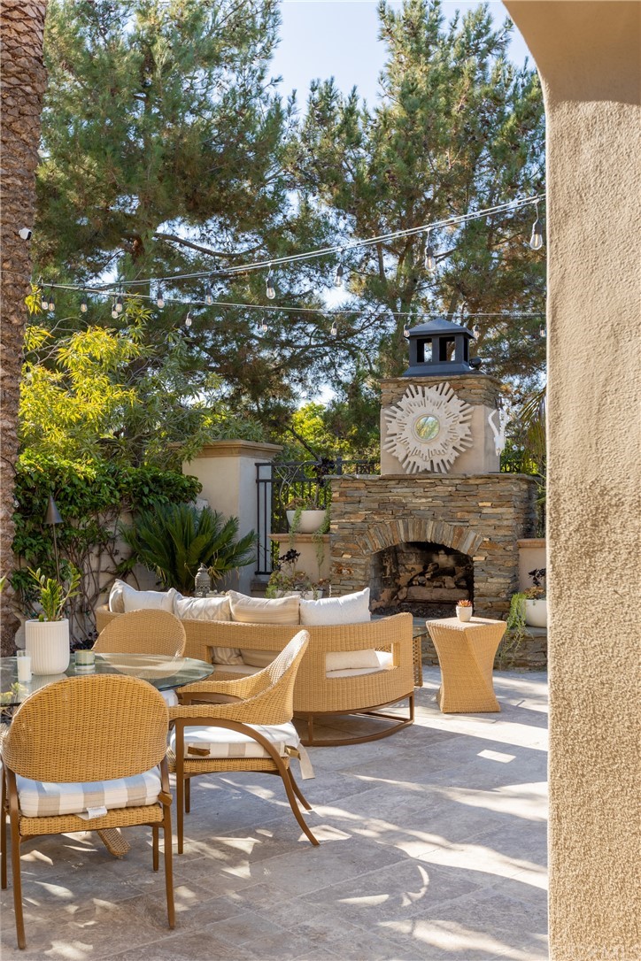 26 Seabluff Newport Beach, CA 92660 - Photo 44 of 59 a view of a patio with table and chairs and potted plants