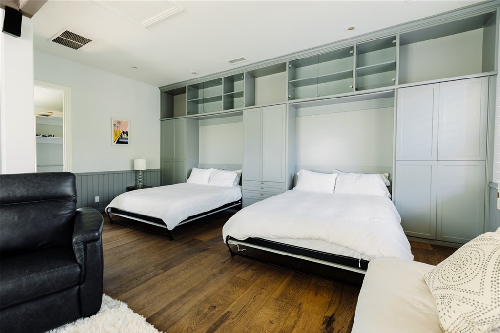 26 Seabluff Newport Beach, CA 92660 - Photo 52 of 59 a bedroom with a bed and wooden floor