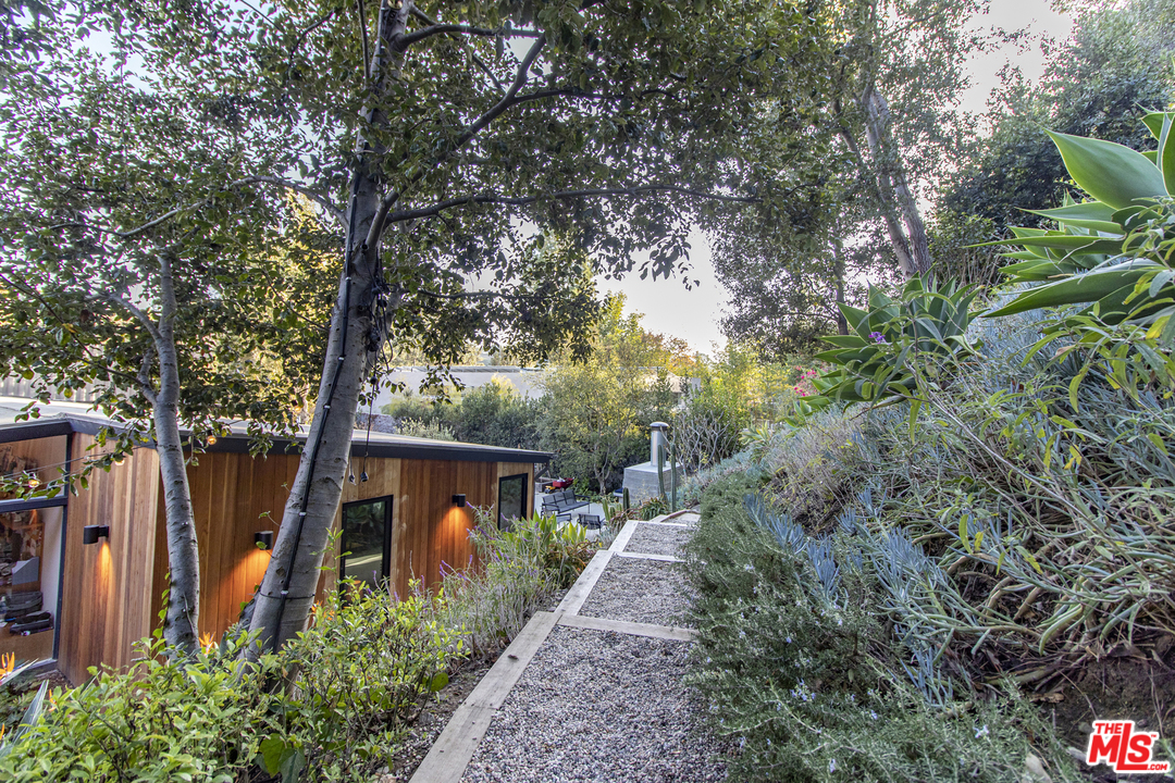535 East Channel Road Santa Monica, CA 90402 - Photo 29 of 41 a front view of a house with a yard and potted plants