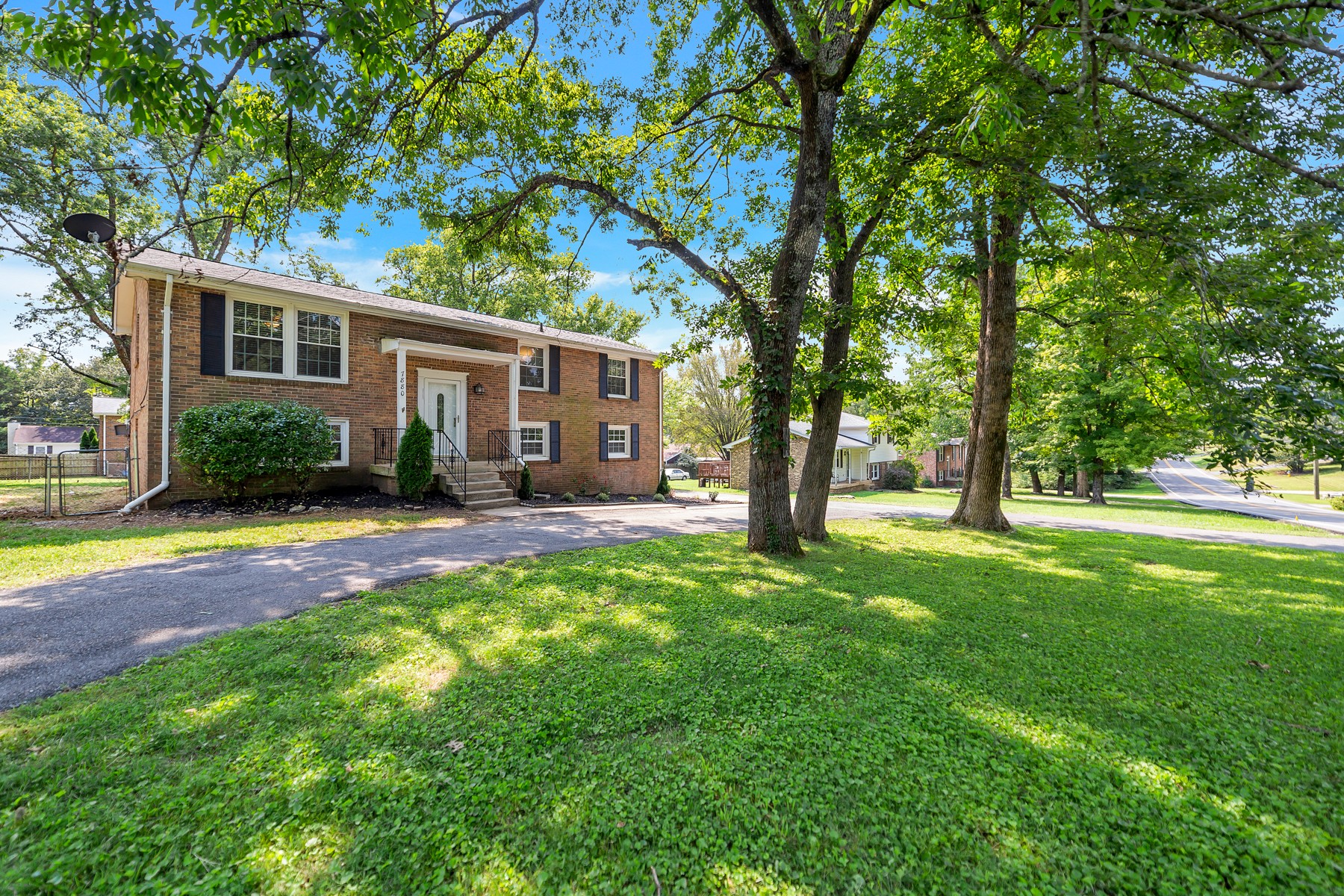 7880 Saundersville Road Mount Juliet, TN 37122 - Photo 1 of 24 a view of a yard with a house and large tree
