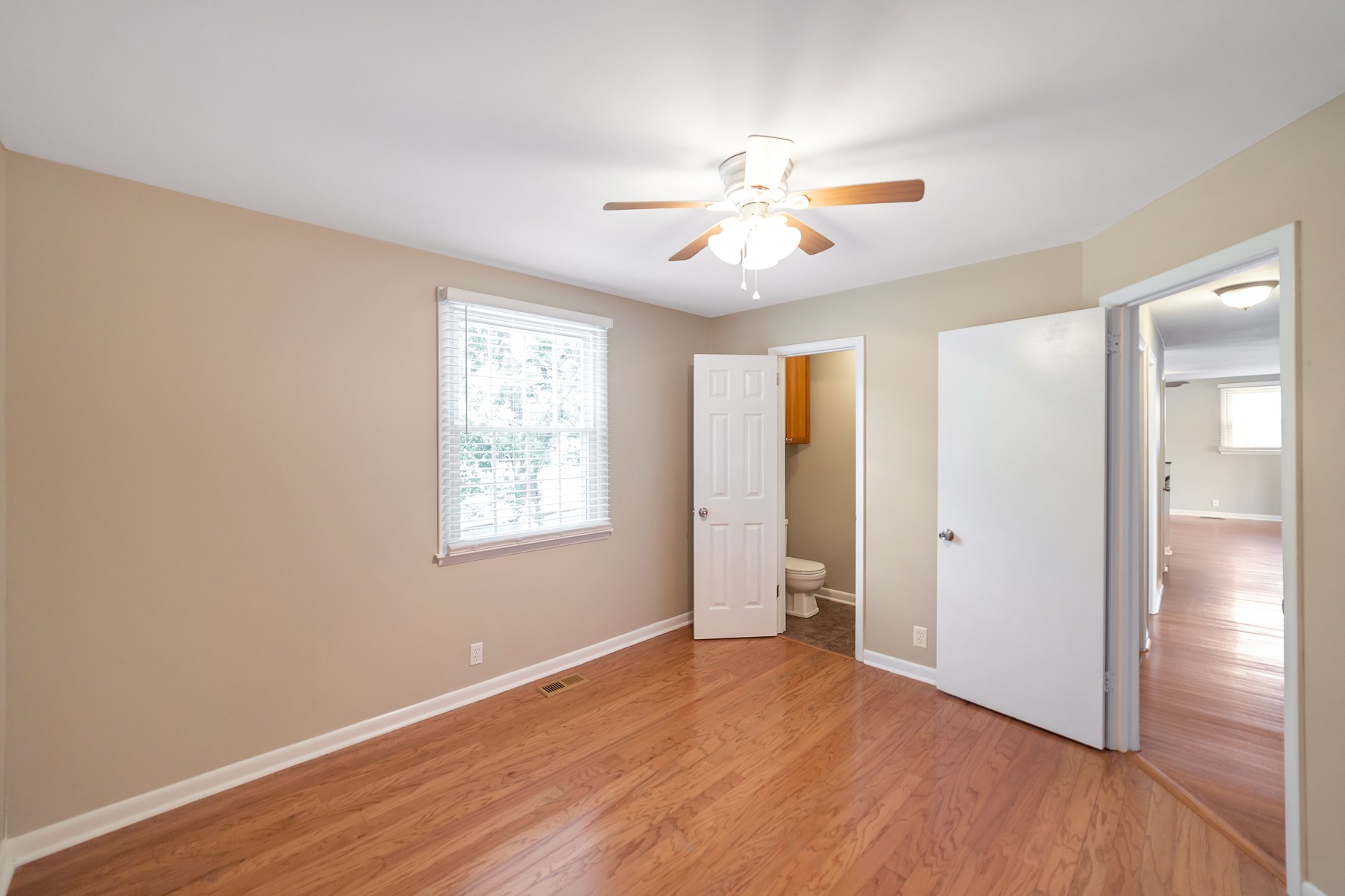 7880 Saundersville Road Mount Juliet, TN 37122 - Photo 6 of 24 an empty room with wooden floor fan and windows